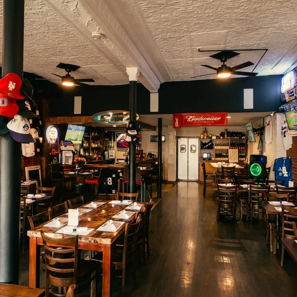 A sports bar with multiple TVs showing baseball, brick walls, wooden tables, and sports memorabilia.